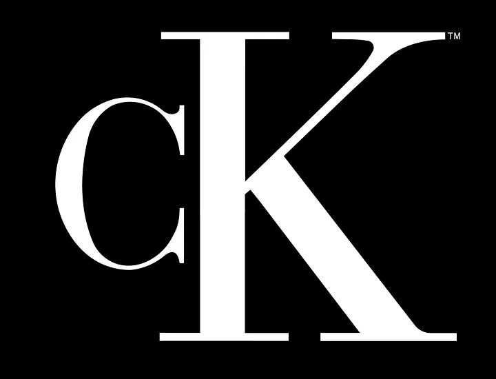 the iconic calvin klein ck monogram logo in white on a solid black background, the c is a smaller, classic serif font, while the k is a larger, more prominent sans-serif font, creating a distinct and memorable brand mark