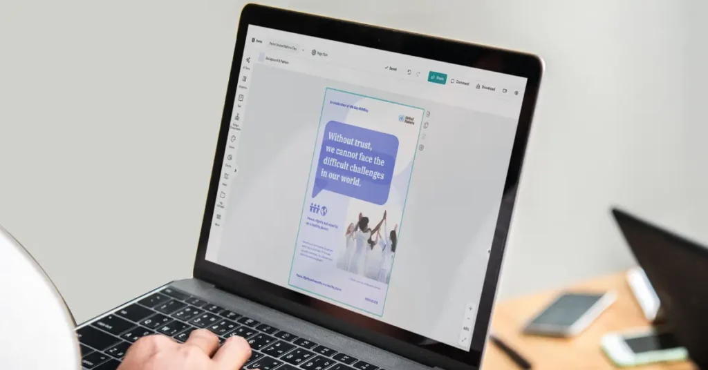a person using design software on a laptop to edit research template posters for a united nations event